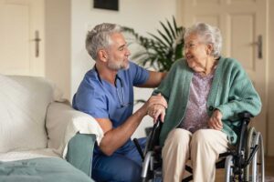 Resident speaking with an assisted living administrator at a table with notes and a grievance form